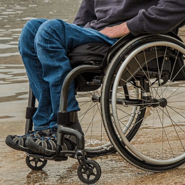 man seated in a manual wheelchair