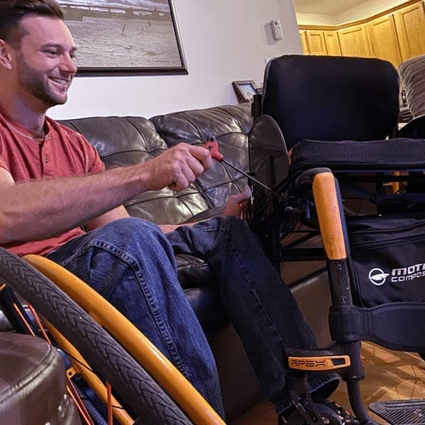 man servicing a motion composites wheelchair