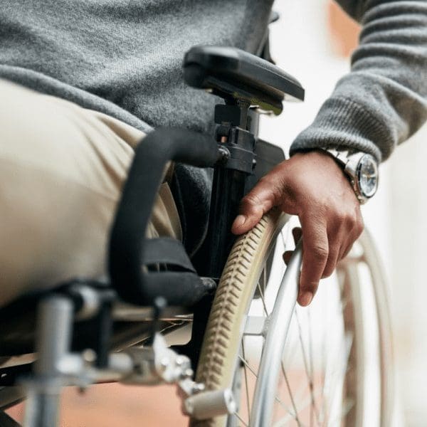 man in basic wheelchair with a watch
