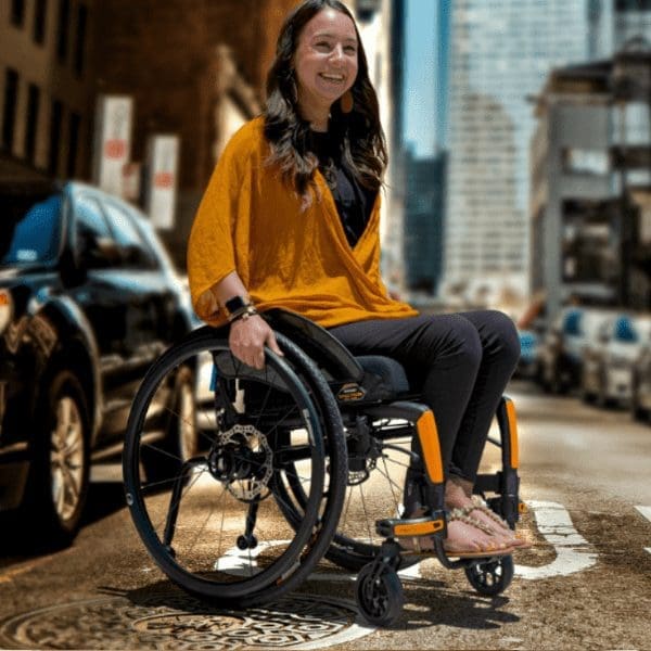 woman in yellow jumper in a wheelchair