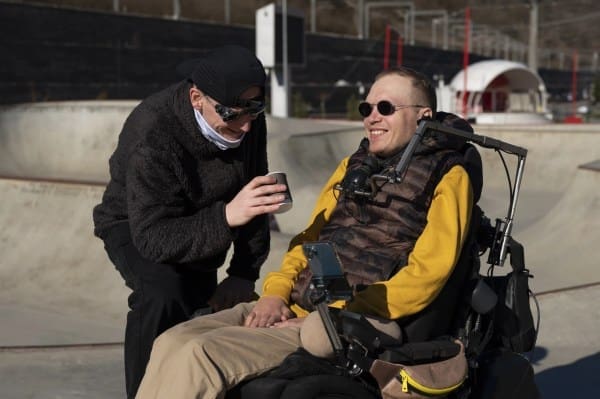 6 medium shot man helping disabled friend scaled 1